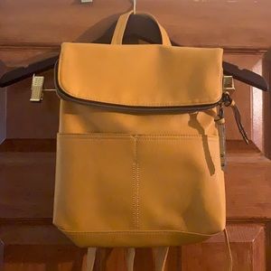 Mustard yellow, medium sized backpack , like new excellent condition, never used